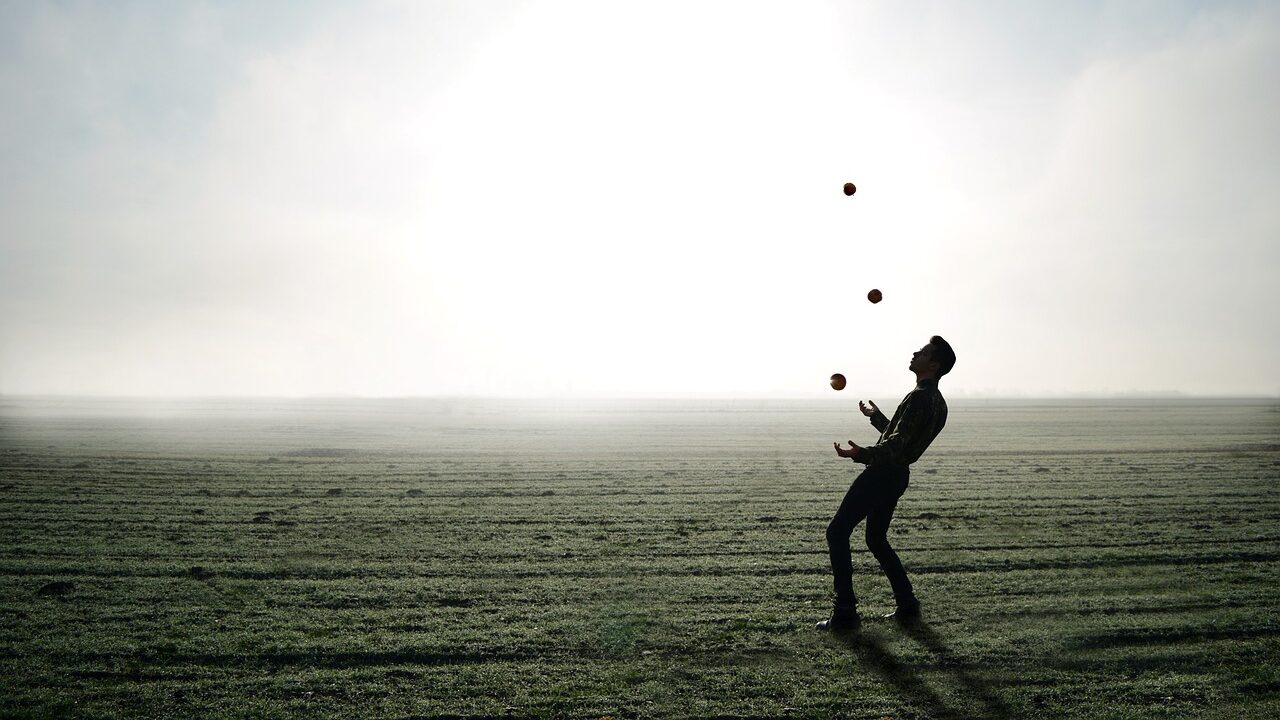 person juggling balls in the air